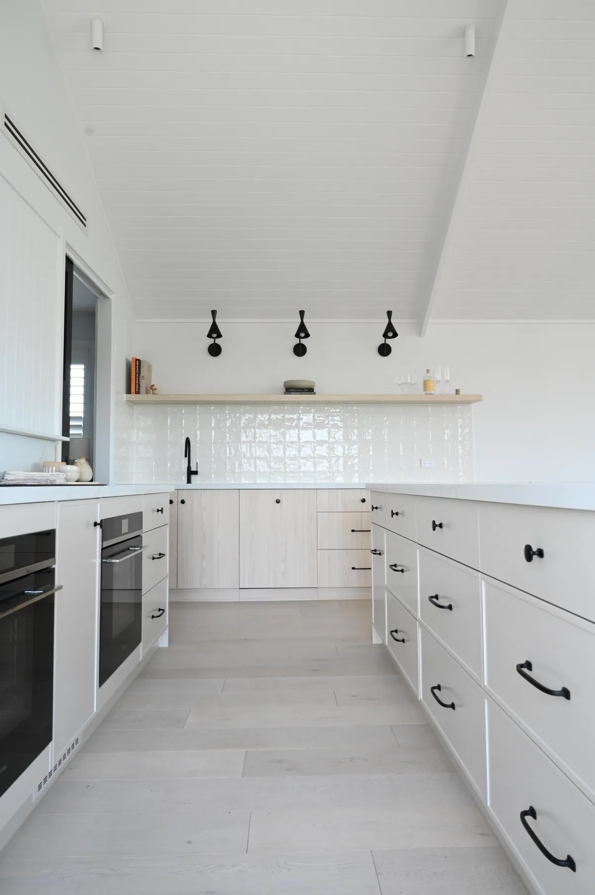 Custom joinery and considered lighting in the Tasman kitchen, Rye